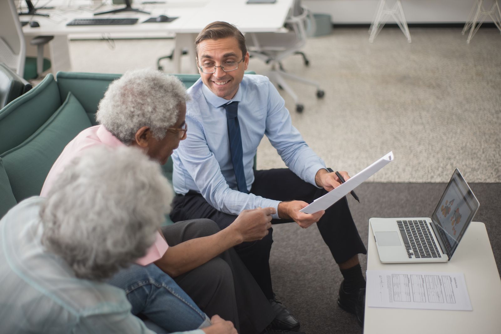 Travel advisor reviewing trip plans with an older couple