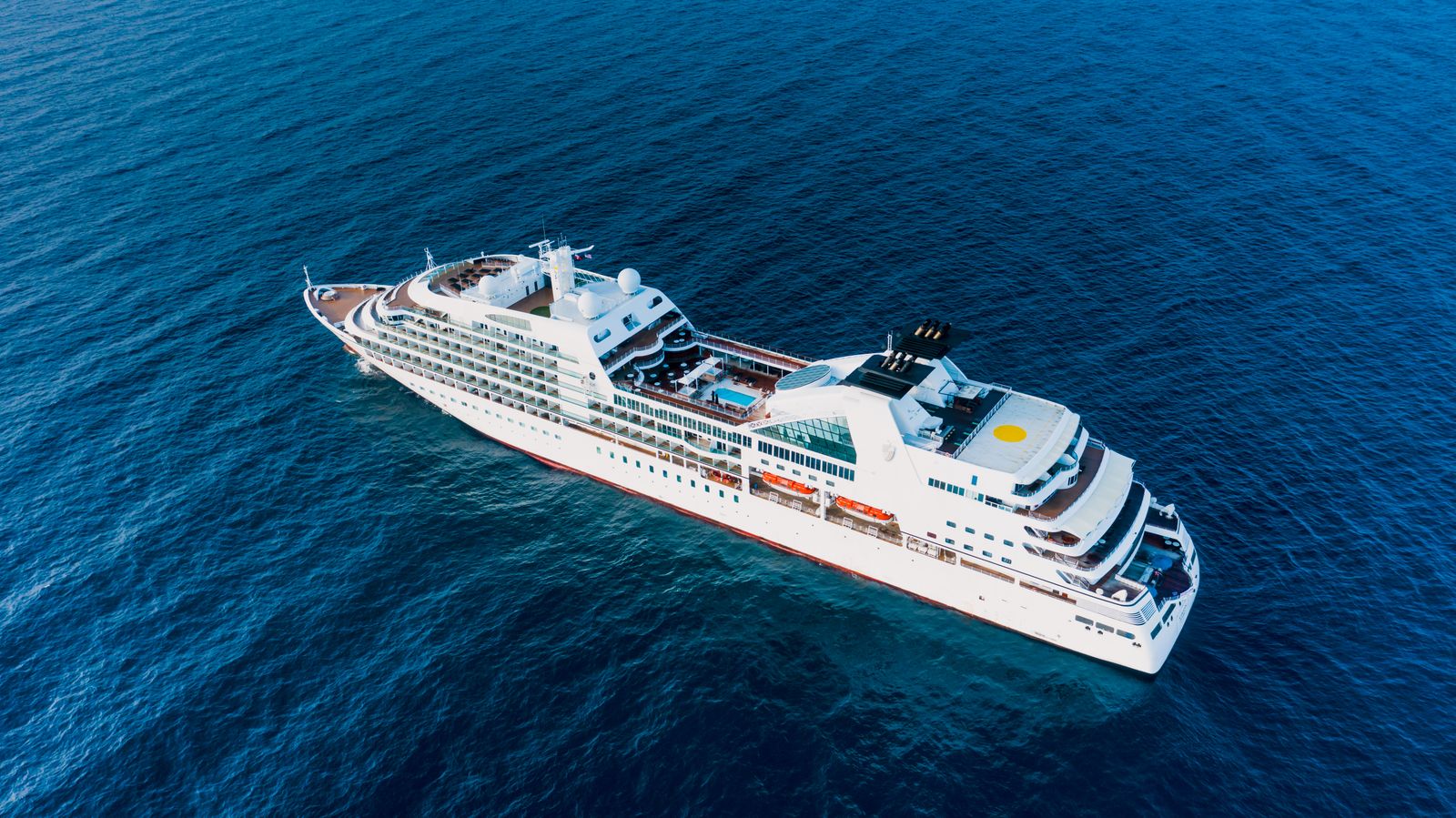 Aerial view of a cruise ship sailing on deep blue sea
