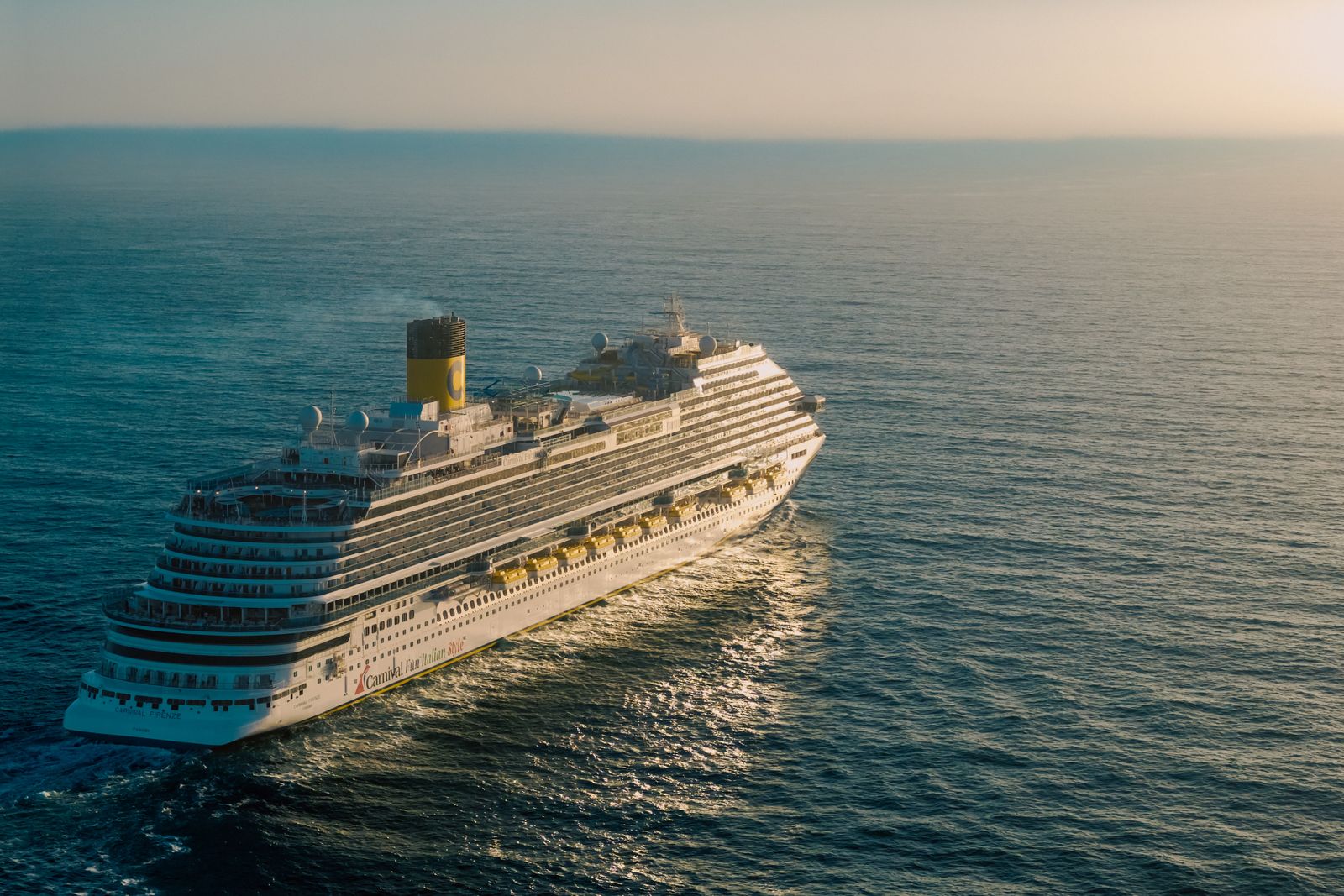 Cruise ship at sea at sunset